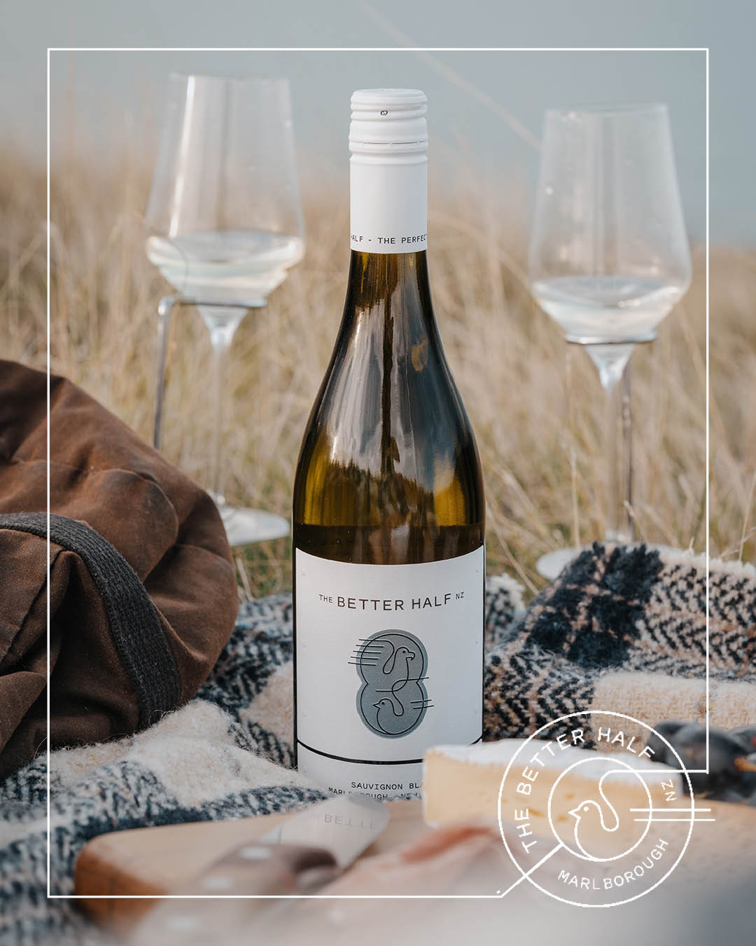 TBH Social 62 The Better Half Sauvignon with two glasses and a picnic blanket